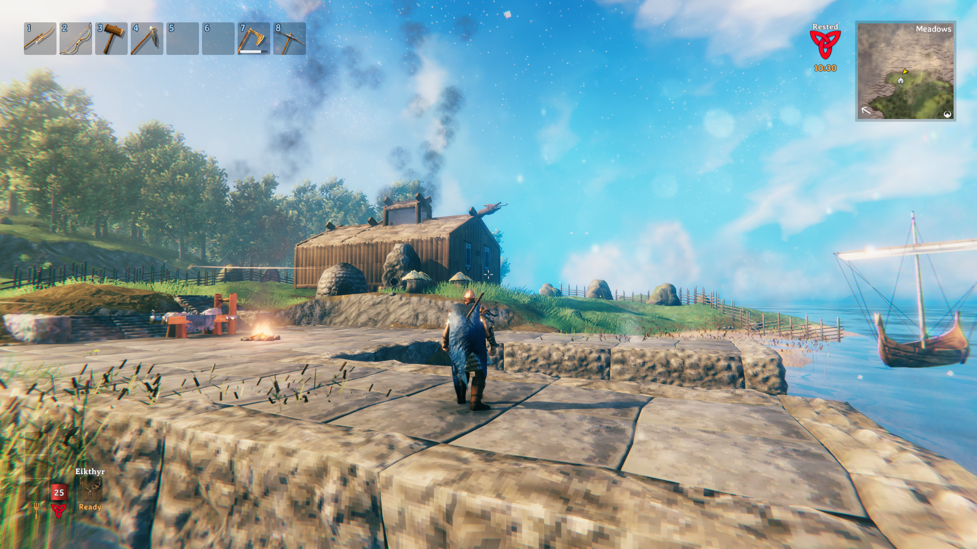 A screenshot from the game Valheim showing off the webmaster's base. There is a modest wooden house in the center and the construction of a stone dock in process nearby.